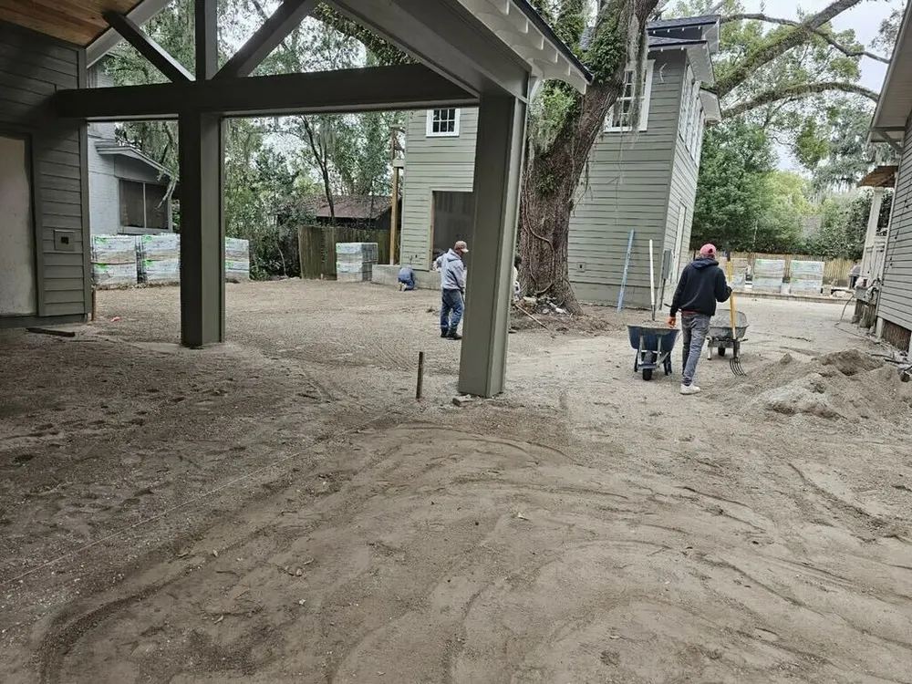 Coastal Driveway Pavers crew preparing and compacting the base for a new paver driveway