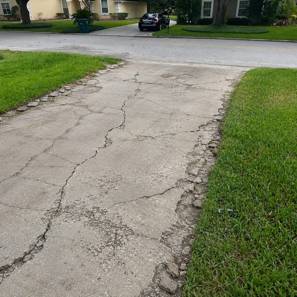 Concrete driveway with severe cracks and crumbling edges in Ponte Vedra Beach, FL