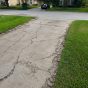 Concrete driveway with severe cracks and crumbling edges in Ponte Vedra Beach, FL